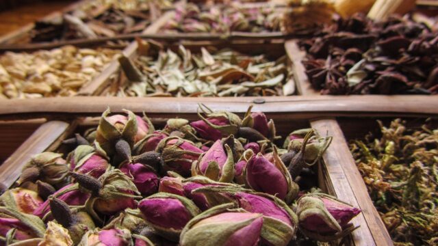 Maghrebi woman trying on Oriental perfumes in a store