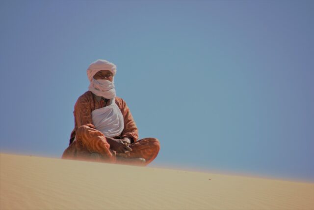 Tuareg Gathering Nomadic Tuareg people gathering around a campfire in the Sahara Desert