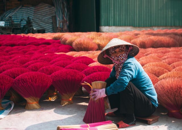 Woman admiring Moroccan artisan crafts, supporting the revival of Morocco's artisanal heritage