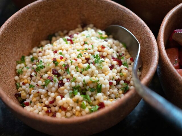 Family enjoying Moroccan style couscous dish during year-round dinner