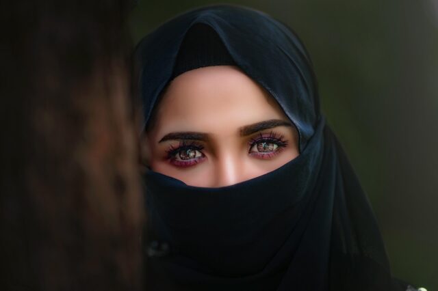 Maghrebi woman trying on a stylish hijab at DAZ Hijab retail shop