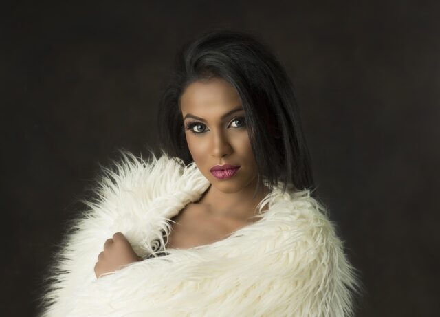 Moroccan woman rearranging bedroom with traditional Moroccan decor elements