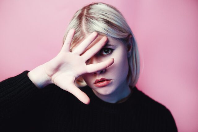 Woman wearing modern Abaya in a Maghrebi setting, symbolizing tradition and contemporary trends