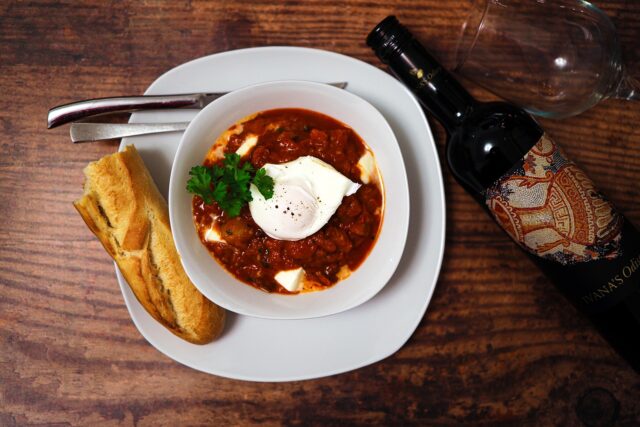 family enjoying authentic shakshuka around Moroccan table