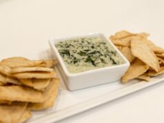 Rediscovering Tunisian Cuisine: A Bold Carrot Dip to Elevate Your Meals Tunisian family enjoying a meal with a bowl of vibrant orange carrot dip on a traditional table