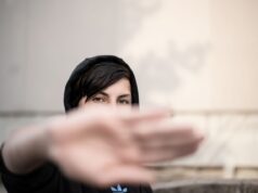 Modern Moroccan Streetwear: Reviving Tradition in the Digital Age Young Maghrebi woman wearing modern streetwear outfit with traditional Moroccan elements in a digital cityscape