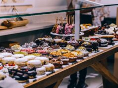 Halal-Certified Pastry Shops in Singapore: A Local’s Perspective for Maghrebi Diaspora A woman enjoying halal pastries at a vibrant pastry shop in Singapore, surrounded by various dessert options