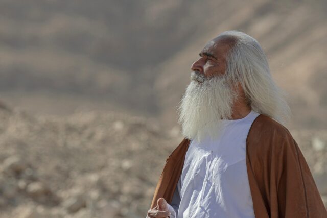 family enjoying Middle Eastern sweets, including baklava, knafeh, and basbousa, at a Maghrebi gathering