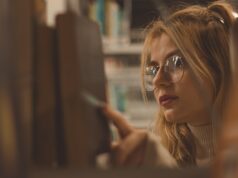 Exploring the Influence of Middle Eastern and North African Visual Art: A Journey Through Time and Culture Woman examining intricate Middle Eastern and North African visual artwork