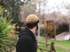 A Deep Dive into Moroccan Jewish Culture through an Ethnographic Lens Moroccan Jewish woman in traditional attire holding a Torah scroll
