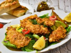 Savoring the Flavors of Home: A Delicious Curried Chicken Couscous Salad Recipe A vibrant plate of curried chicken couscous salad served with fresh herbs and colorful vegetables