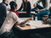 Halal Certification: Understanding SIA’s Muslim Meals Amid Online Discussion Group of people discussing Halal Certification for Muslim Meals at SIA