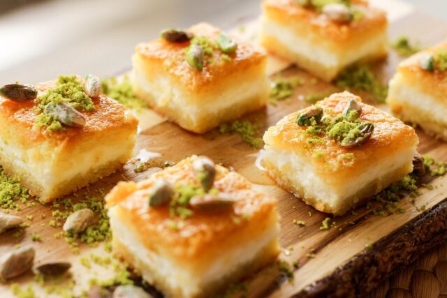 Eid cookies and traditional Middle Eastern and North African desserts displayed on a colorful tablecloth