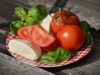 Fresh Couscous Salad: A Taste of Home for the Maghrebi Diaspora A colorful fresh couscous salad served on a wooden table with Maghrebi flags in the background