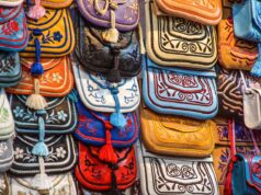 Savoring Moroccan Fashion Week in Marrakech with easyJet: A Maghrebi Diaspora’s Dream Come True A diverse group of people attending Moroccan Fashion Week in Marrakech, surrounded by colorful outfits and vibrant cultural d
