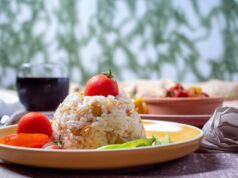 Authentic Algerian Iftar Favorites for an Unforgettable Ramadan Family enjoying an Algerian Iftar feast, with sizzling meat and aromatic dishes on the table.