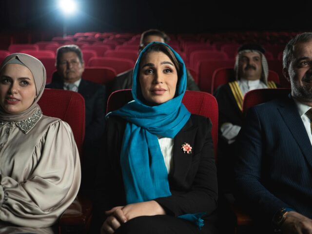 Empowering Arab Women in Cinema Maghrebi women in a cinema setting, discussing and collaborating on a film project