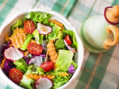 Fresh Quinoa Salad with Algerian Harissa Dressing – A Delicious Addition to Your Summer BBQs Fresh quinoa salad served on a wooden platter, garnished with herbs and drizzled with harissa dressing at an outdoor summer B