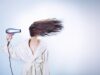 Natural Hair Care with Nigella Oil: A Comprehensive Guide for Maghrebi Readers Maghrebi woman applying nigella oil to her hair in a traditional setting