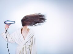 Natural Hair Care with Nigella Oil: A Comprehensive Guide for Maghrebi Readers Maghrebi woman applying nigella oil to her hair in a traditional setting