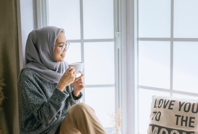 Maghrebi woman wearing modest Muslim fashion in a Western academic setting