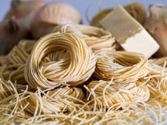Exploring Authentic Pasta Salad Recipes Inspired by Maghrebi Cuisine Woman preparing a colorful pasta salad with Maghrebi spices