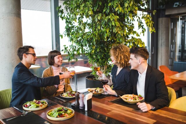 Group of people enjoying a halal brunch, featuring Middle Eastern dishes and vibrant decor