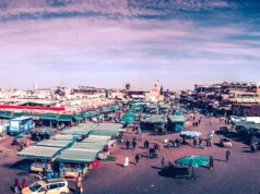 Breaking Records in Morocco: A Look at the Exceptional Tourist Arrivals for 2023 Crowded marketplace in Morocco with tourists exploring traditional stalls and artifacts