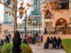 Empowerment Lessons from Arab Women Living in Various Cultural Contexts Arab woman posing confidently in traditional Maghrebi attire against a backdrop of diverse global cityscape