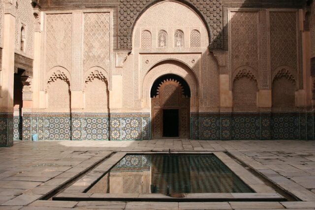 Artisan working on intricate Moroccan zellige tile in traditional workshop