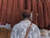 Exploring the Impact of Islamic Culture on Global Fashion: A Journey Through Maghrebi Influence Woman wearing traditional Maghrebi clothing in a bustling market