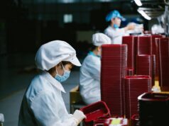 Robots Revolutionizing the Clothing Industry in North Africa: A Game Changer for the Maghrebi Diaspora Robots working on sewing machines at a clothing factory in North Africa, Maghrebi workers observing