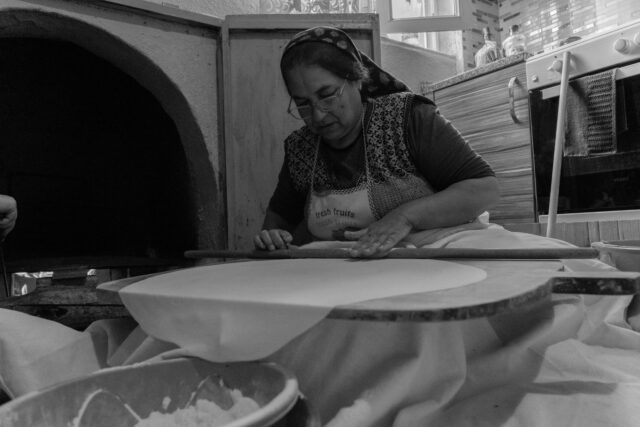 Tunisian Yabrak Preparation Woman preparing yabrak dish in Marseille kitchen, Passover celebration