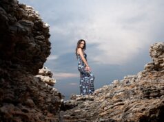 Reviving Amazigh Identity through Modern Art and Fashion: A Cultural Renaissance Woman wearing traditional Amazigh clothing and accessories with modern art in the background