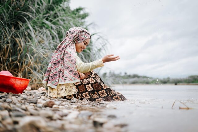Maghrebi fashion modern woman Modern Muslim woman wearing traditional attire with intricate henna designs and statement jewelry