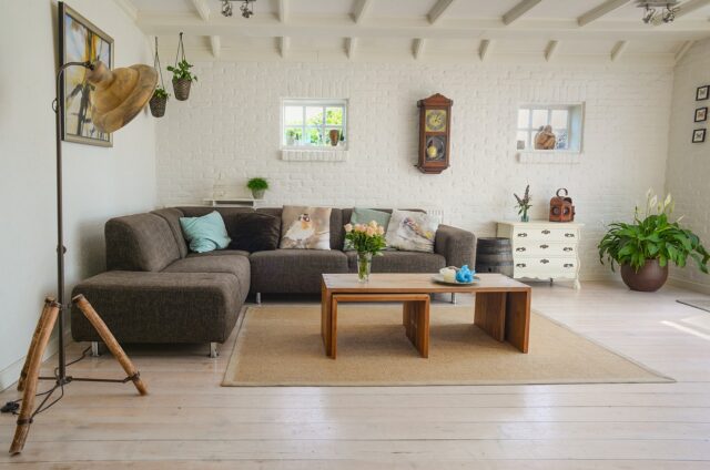 Woman arranging Moroccan-inspired cushions and rugs in a living room