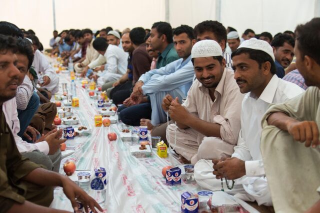 Ramadan Maghreb Duck Breasts Family enjoying a traditional Ramadan meal of spiced duck breasts with preserved lemons in the Maghreb region