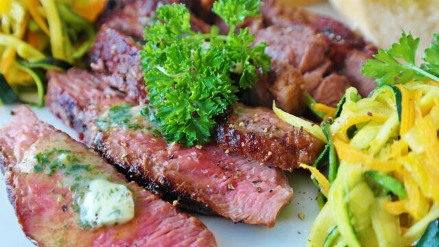 Grilled Salsa Verde and Salsa Roja Steak Grilled steak served with Salsa Verde and Salsa Roja, surrounded by Algerian, Tunisian, and Moroccan flag elements