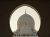 Celebrating Revolutionary Literature: Eight Must-Read Novels by Arab Women Eight Arab women authors holding their books, sitting around a table with a backdrop of Middle Eastern architecture