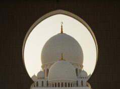 Celebrating Revolutionary Literature: Eight Must-Read Novels by Arab Women Eight Arab women authors holding their books, sitting around a table with a backdrop of Middle Eastern architecture