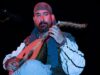 Remembering the Life and Legacy of Berber Troubadour Idir Idir performing on stage with traditional Berber instruments