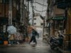 Unveiling the Judeo-Amazigh Cultural Substratum: A Deep Dive for Maghrebi Diaspora Readers Maghrebi woman wearing traditional Judeo-Amazigh jewelry and headpiece in a historic marketplace