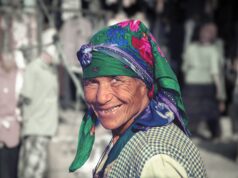 Preserving Traditions and Embracing Modern Identity: The Amazigh Culture in Tunisia Woman wearing traditional Amazigh attire amidst modern Tunisian cityscape