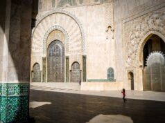 Discovering the Charm of Moroccan Riads: Your Home Away from Home on Airbnb Moroccan Riad with a tranquil courtyard, featuring a fountain, palm trees, and cozy seating