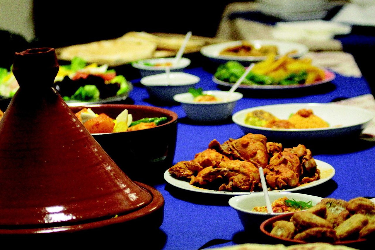 Moroccan Spiced Chicken Tagine served on a rustic table with Moroccan tiles in the background