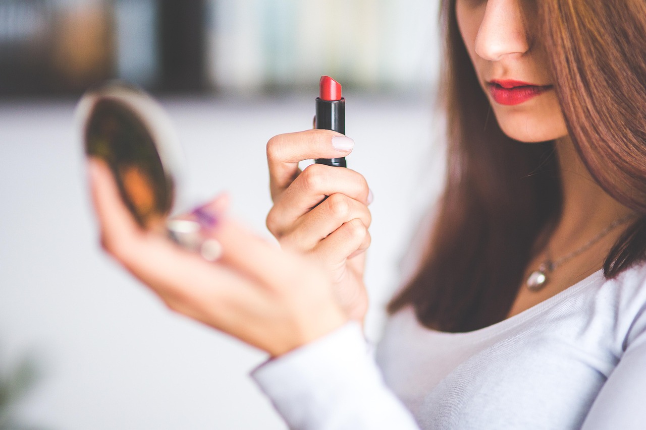 Woman applying nigella oil on her long, healthy hair