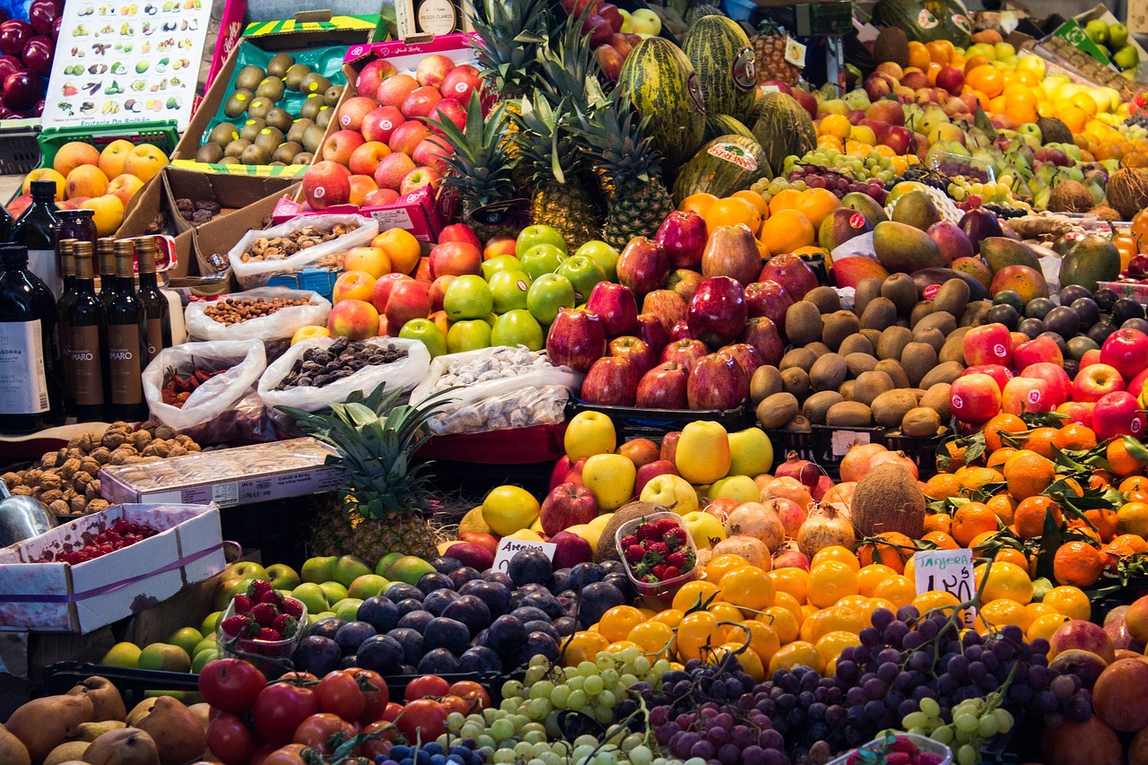 Dave Patera exploring a bustling souk in Marrakech, Morocco, surrounded by spices, fresh produce, and traditional North Afric